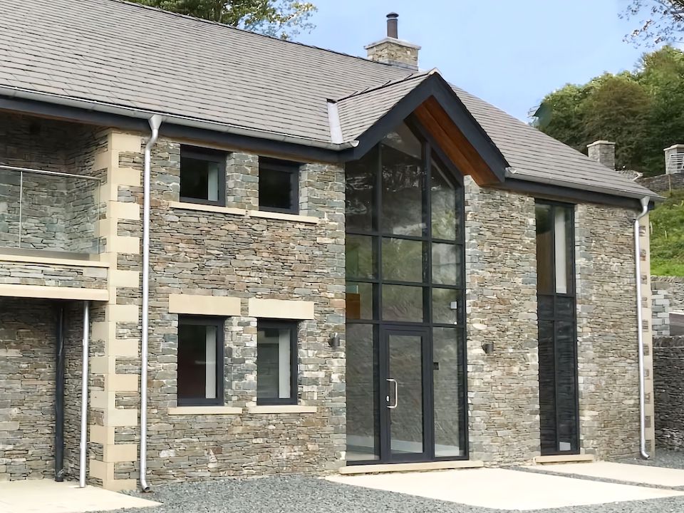 house entrance hall with full building height feature windows at Lake District property