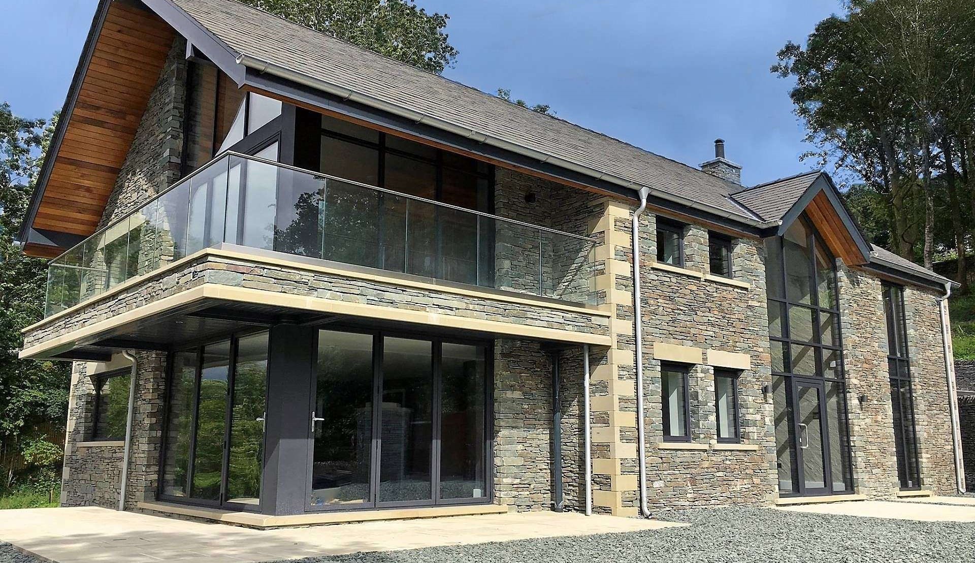 New build project in Windermere with aluminium bifold doors, feature glazing, casement windows and curtain wall